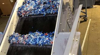 Textile waste being processed for recycling via carbon renewal technology.