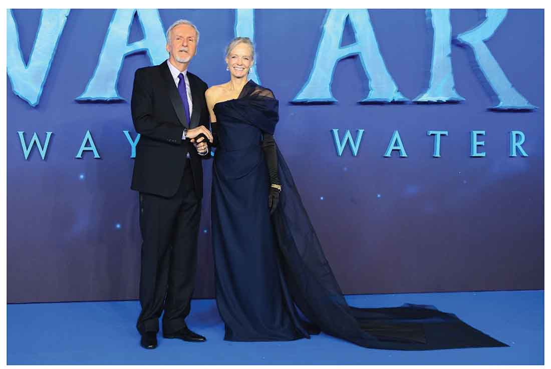 Hollywood power couple James Cameron (left) and Suzy Amis Cameron (right) in bespoke looks by Huntsman and Vivienne Westwood made of TENCEL™ branded lyocell fibers at the London premiere of AVATAR: The Way of Water. Suzy Amis Cameron’s dress is made of fabric with 58% TENCEL™ Lyocell and 42% Acetate.James Cameron’s suit is fabric made of 100% TENCEL™ Lyocell. Getty Images/ RCGD Global