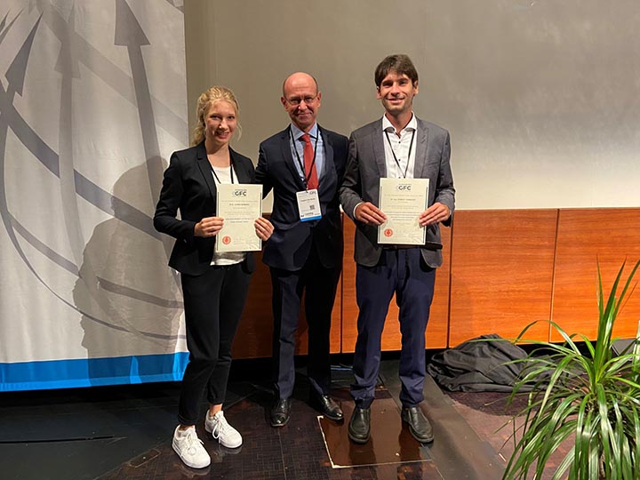 Frédéric Van Houte, director general of CIRFS (center), presenting the Paul Schlack/Wilhelm Albrecht prizes to Robert Tonndorf of the Technische Universität Dresden, Germany (right), and Leonie Reinders of DITF Denkendorf, Germany. Photo courtesy Dornbirn GFC