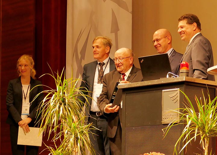 Professor Hilmar Fuchs (center) receiving the lifetime achievement award. Photo courtesy STFI