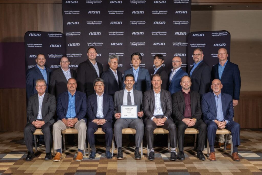 Alexander Pichi, Sales & Marketing, Tailored Urethanes NA, Covestro LLC, receives the award on behalf of Covestro from the AISIN leadership team.