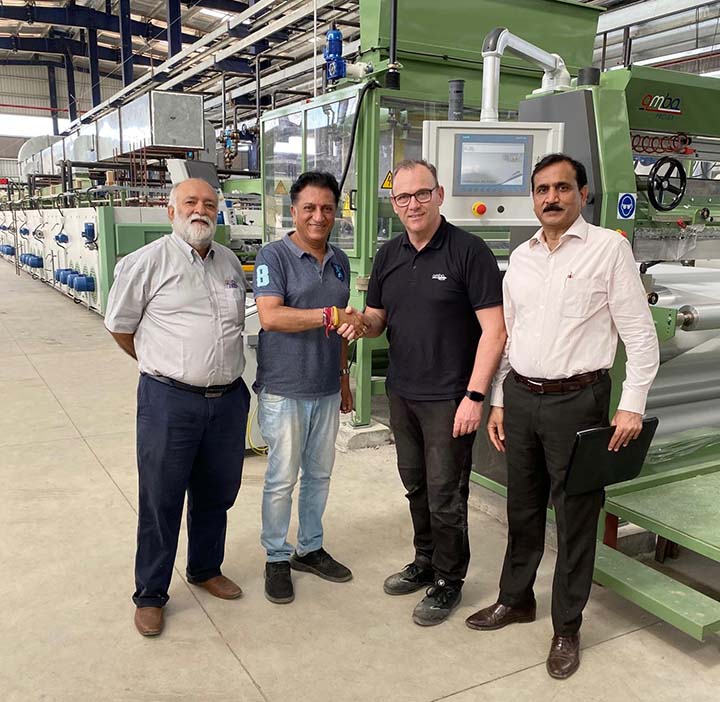 Pictured at the new installation (left to right) are Jayessh S Nanavati of Sainite Exports, JR Mehta of Candour Techtex, Barry Goodwin, and Sanjay Jain, Amba's coating technologist in India.