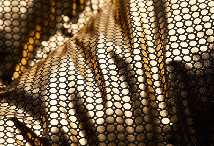 Omni-Heat Infinity 
visually is a series of gold dots. On a jacket, it’s the inside layer which reflects body heat. It was originally inspired by the reflective insulations that NASA has uses in their space materials. 