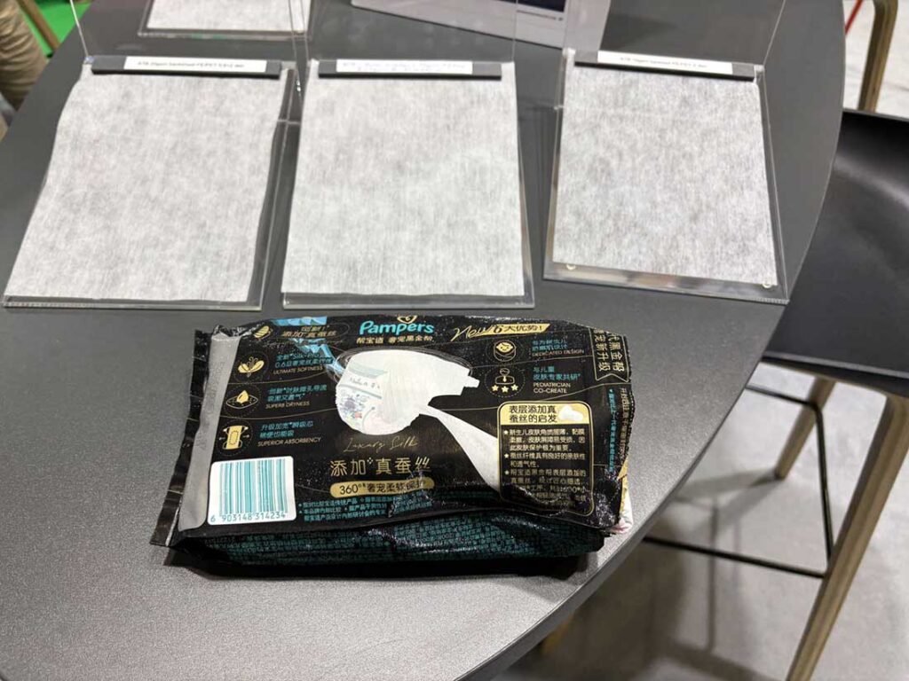 Fine fiber nonwovens samples and premium Pampers diapers now promoting softness in China, displayed on the Trützschler stand in Geneva. Photo courtesy of A.Wilson
