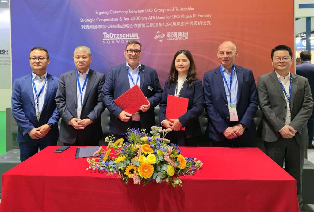Liao Group announced a major expansion program during the recent INDEX™26 in Geneva, involving 10 additional 4.2 meter ATB lines. (left to right): ZhengYu Hu and WeiZhong Zhu of Trützschler Jiaxing, Trützschler Nonwovens MD Matthias Schemken, MeiLing Chen, Liao Group’s director of procurement, Trützschler China general manager Harald Schoepp and Weiping Zhang of Trützschler Jiaxing. Photo courtesy of Trützschler
