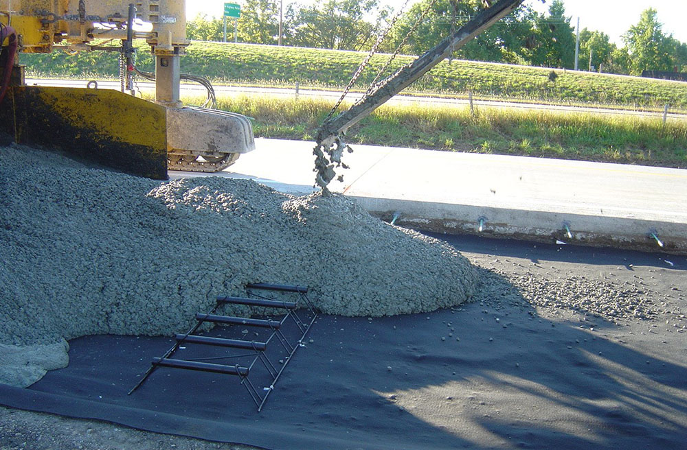 Geotextile installed directly on top of the existing concrete pavement